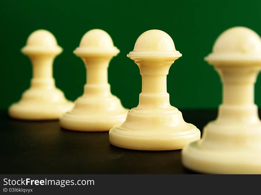 Shows four pawns on a green background