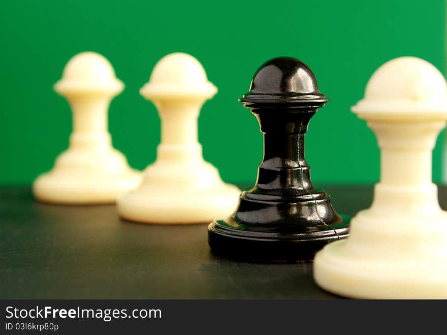 Shows four pawns on a green background