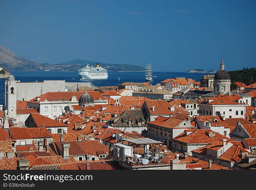 A photograph of a cruise liner and a sailboat outside the ancient city of Dubrovnik in Croatia. A photograph of a cruise liner and a sailboat outside the ancient city of Dubrovnik in Croatia