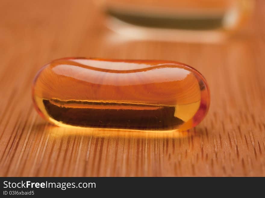 Medical pill against diseases on a wooden table.