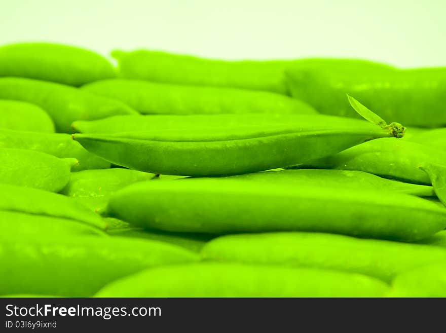 Rows of fresh green peas in a pod.