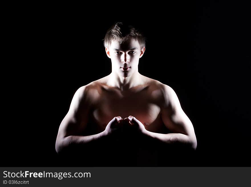 Fashion portrait of the young beautiful man in studio