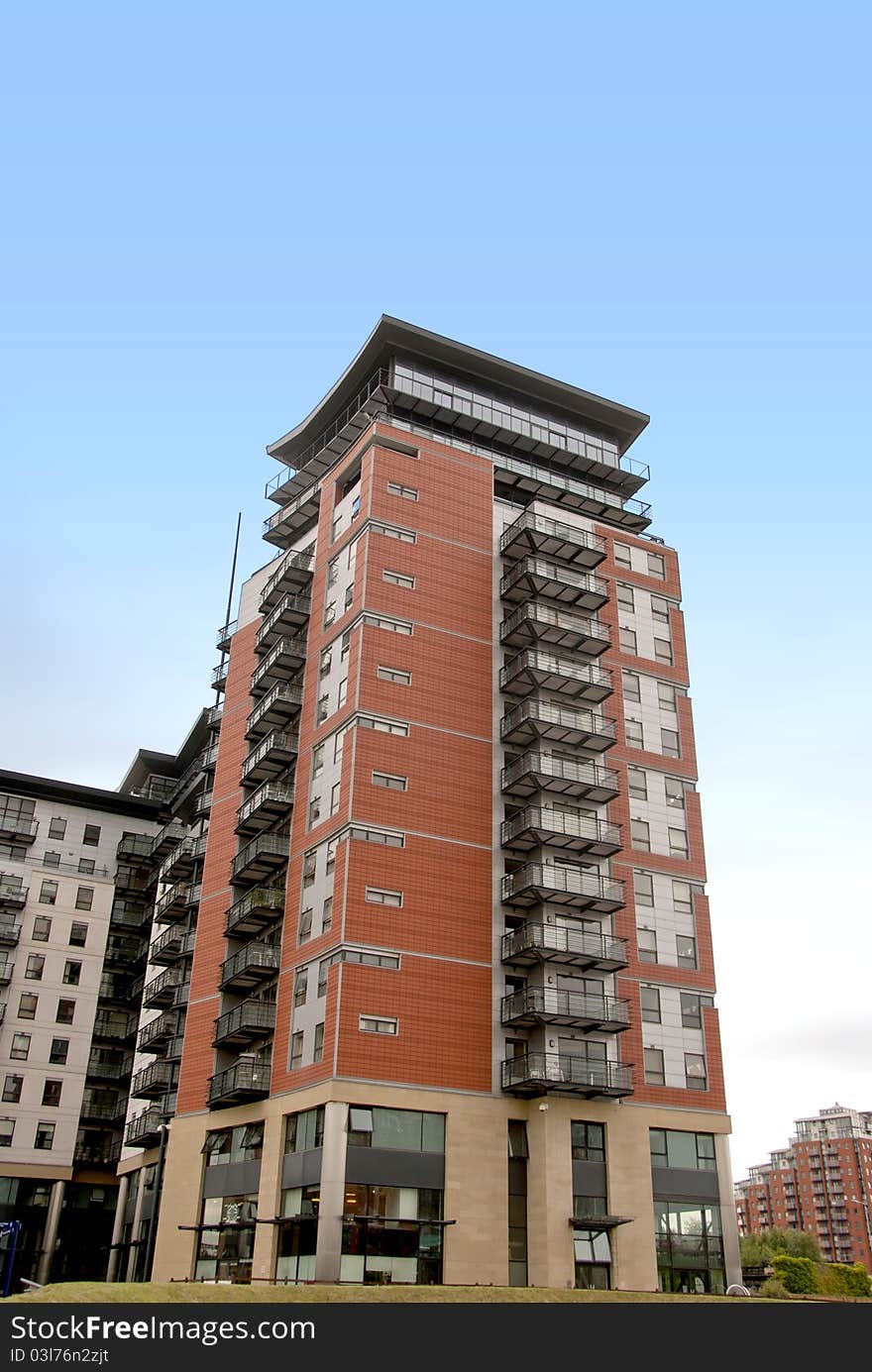 Luxury Red and Black Apartment blocks in a Yorkshire City under a blue sky. Luxury Red and Black Apartment blocks in a Yorkshire City under a blue sky