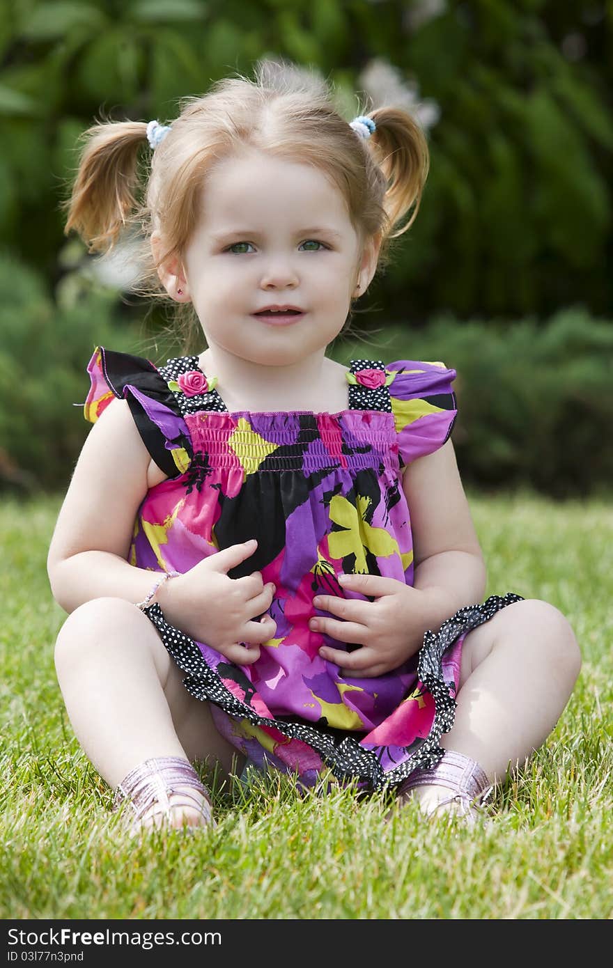 A young girl poses outside