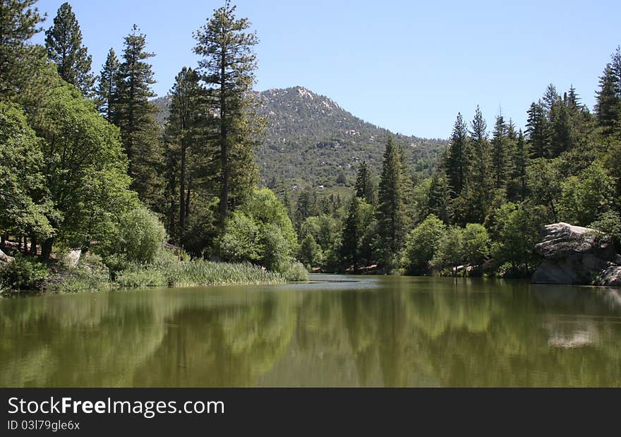 Mountains and pines reflected in Lake Fulmor, Idyllwild, CA