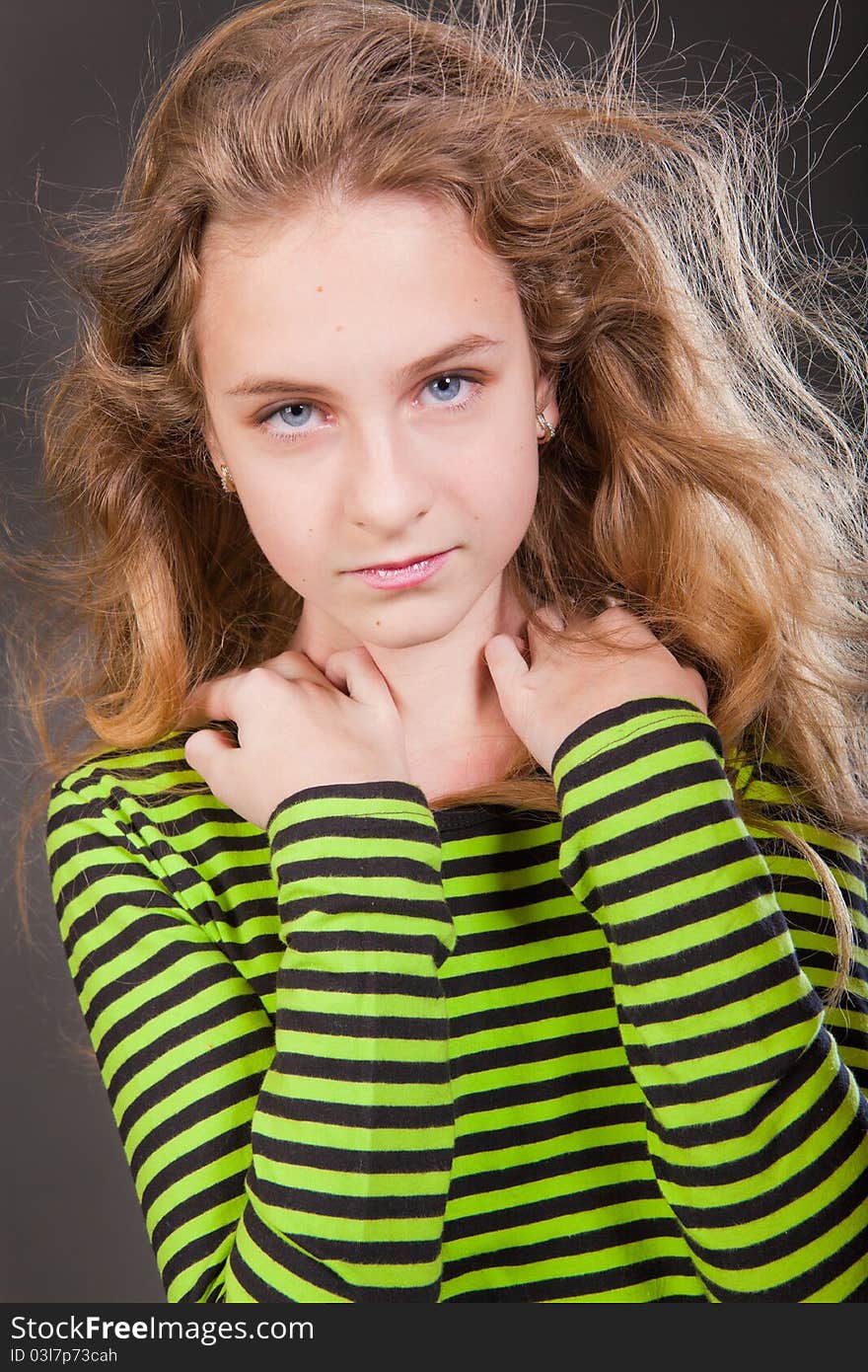 Portrait of happy girl teenager in studio