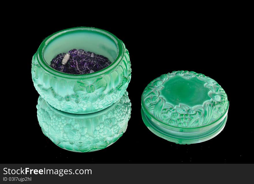 Malachite box with a lid for bijouterie with a lid on a black background