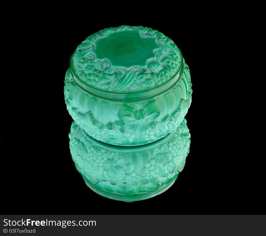 Malachite box with a lid for bijouterie with a lid on a black background