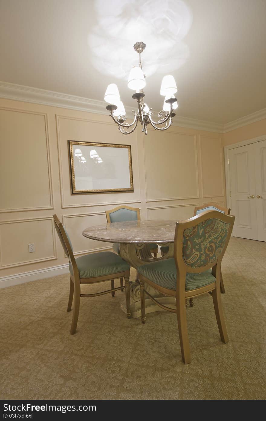 Round Marble Table Surrounded By Chairs