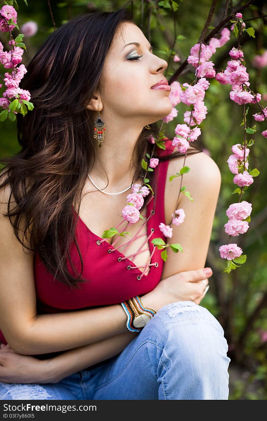 Woman in garden with pink flowers