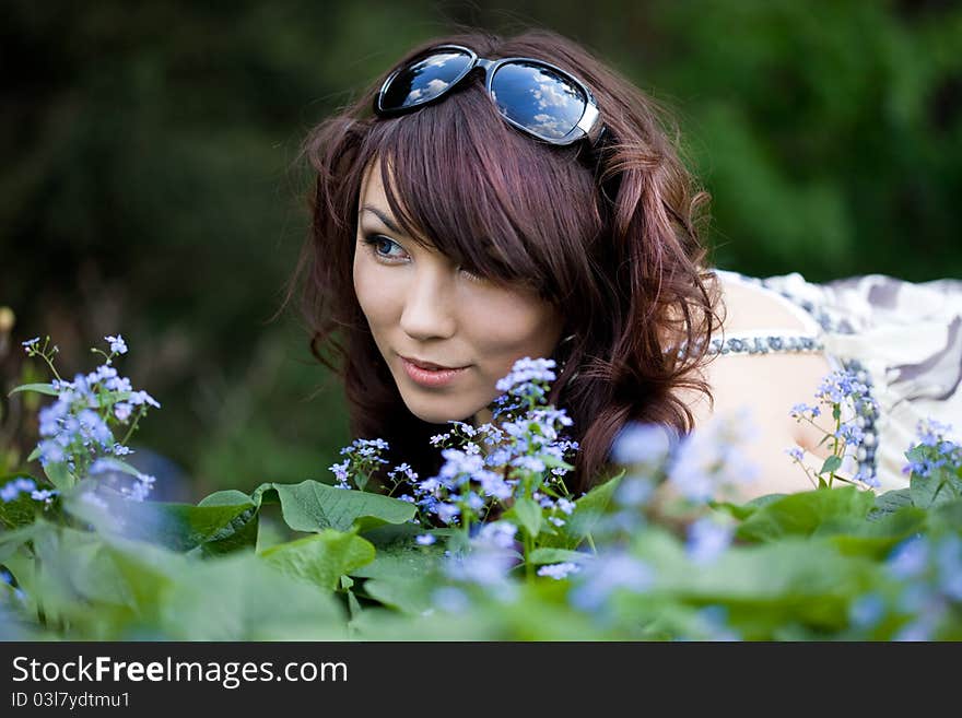 Tender girl in the garden with flowers