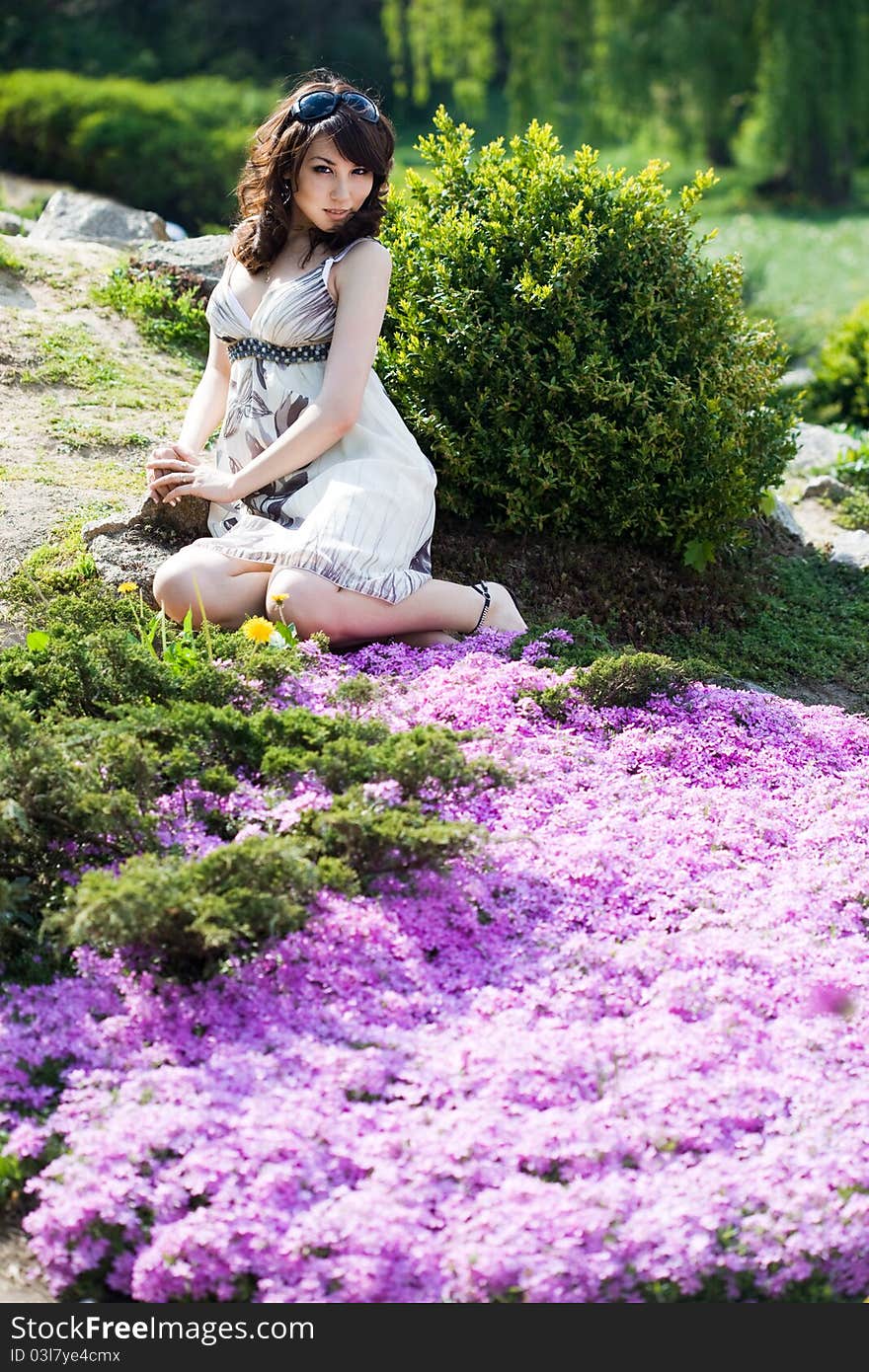 Tender girl in the garden with flowers