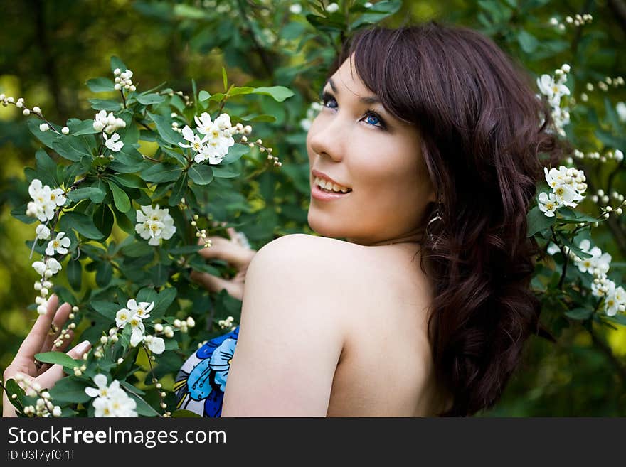 Tender girl in the garden with flowerings trees