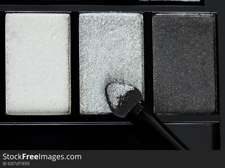 Make-up eyeshadows and cosmetic brush