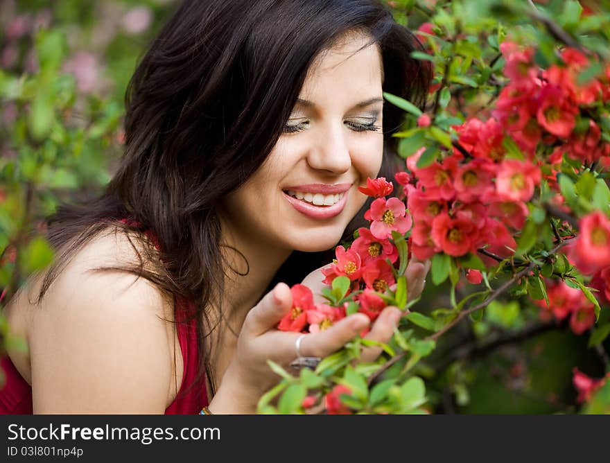 Woman in garden with red flowers