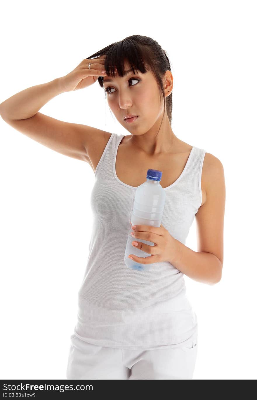 Young exhausted woman holding a bottle of water after workout. Young exhausted woman holding a bottle of water after workout.