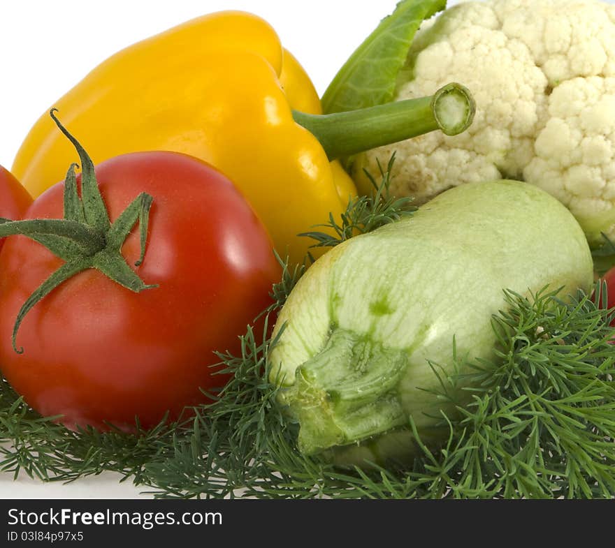 Tomato, pepper, vegetable marrow lie on a dill on a white background. Tomato, pepper, vegetable marrow lie on a dill on a white background