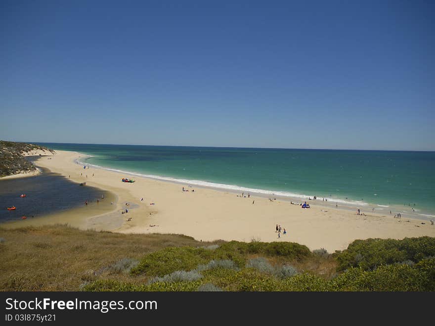 Indian Ocean and Moore River, north of Perth in Western Australia, almost meet, just a narrow stretch of beach keeps both waters apart. A popular weekend destination for people living in Perth. Indian Ocean and Moore River, north of Perth in Western Australia, almost meet, just a narrow stretch of beach keeps both waters apart. A popular weekend destination for people living in Perth.