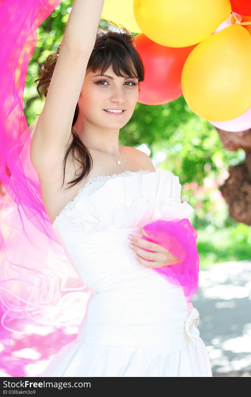 Beautiful Bride with colorful balloons the air