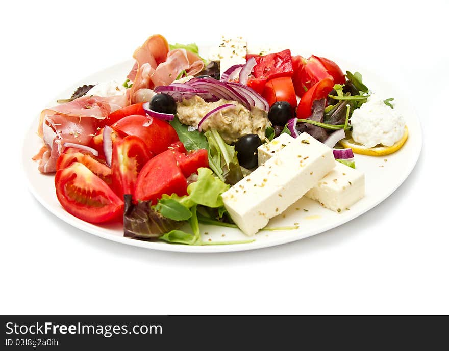 Appetizer of mixed meat, vegetables and cheese (shallow  DOF, focus in the middle)