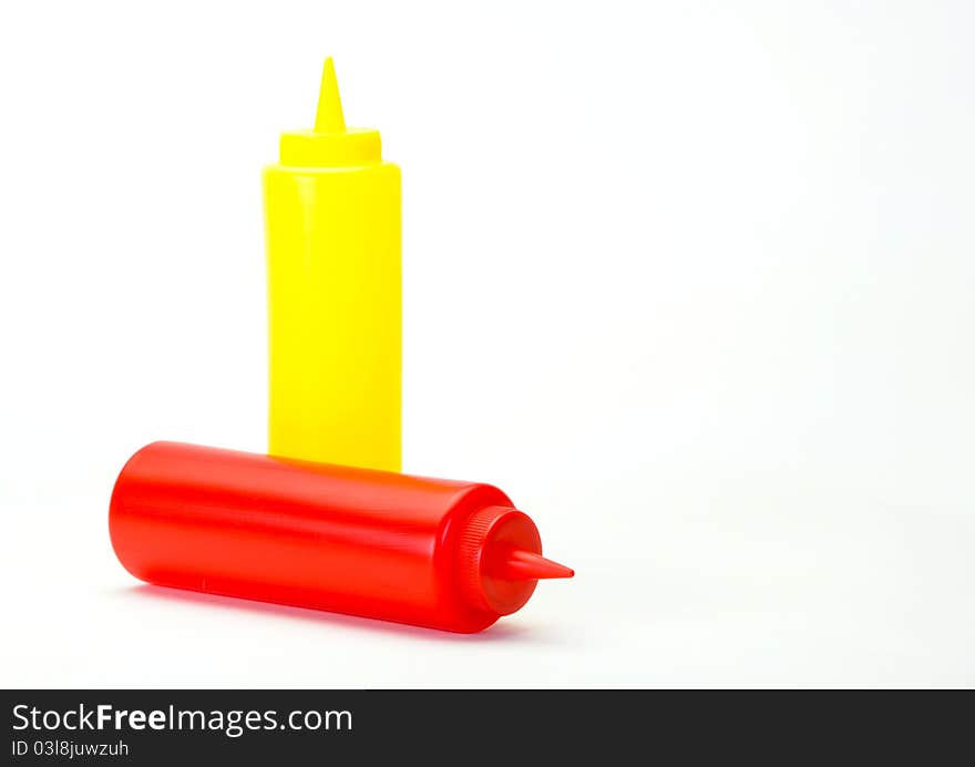 Red Ketchup and yellow mustered dispenser isolated on white background