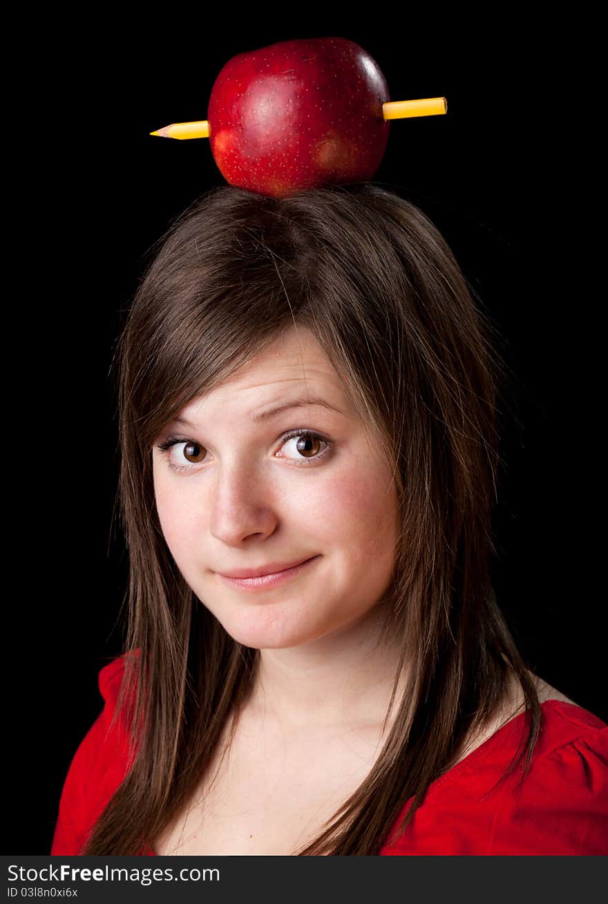Beautiful student woman have one apple with pencil on her head - learning concept-