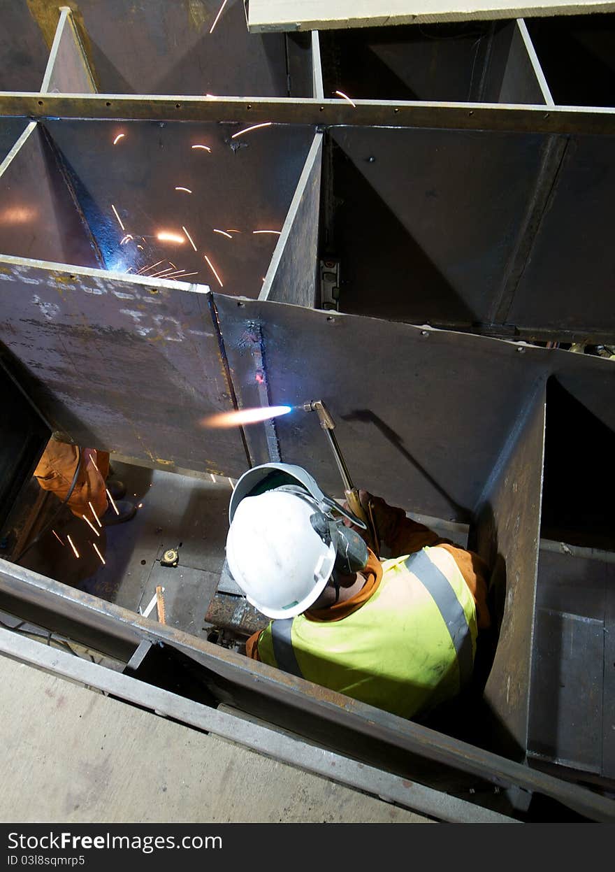 Worker using a gas torch in an industrial setting. Worker using a gas torch in an industrial setting