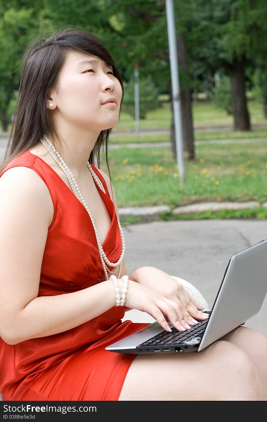 Girl working on laptop outdoor