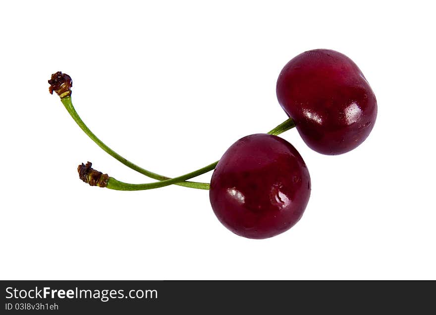 Two red cherries on a white background