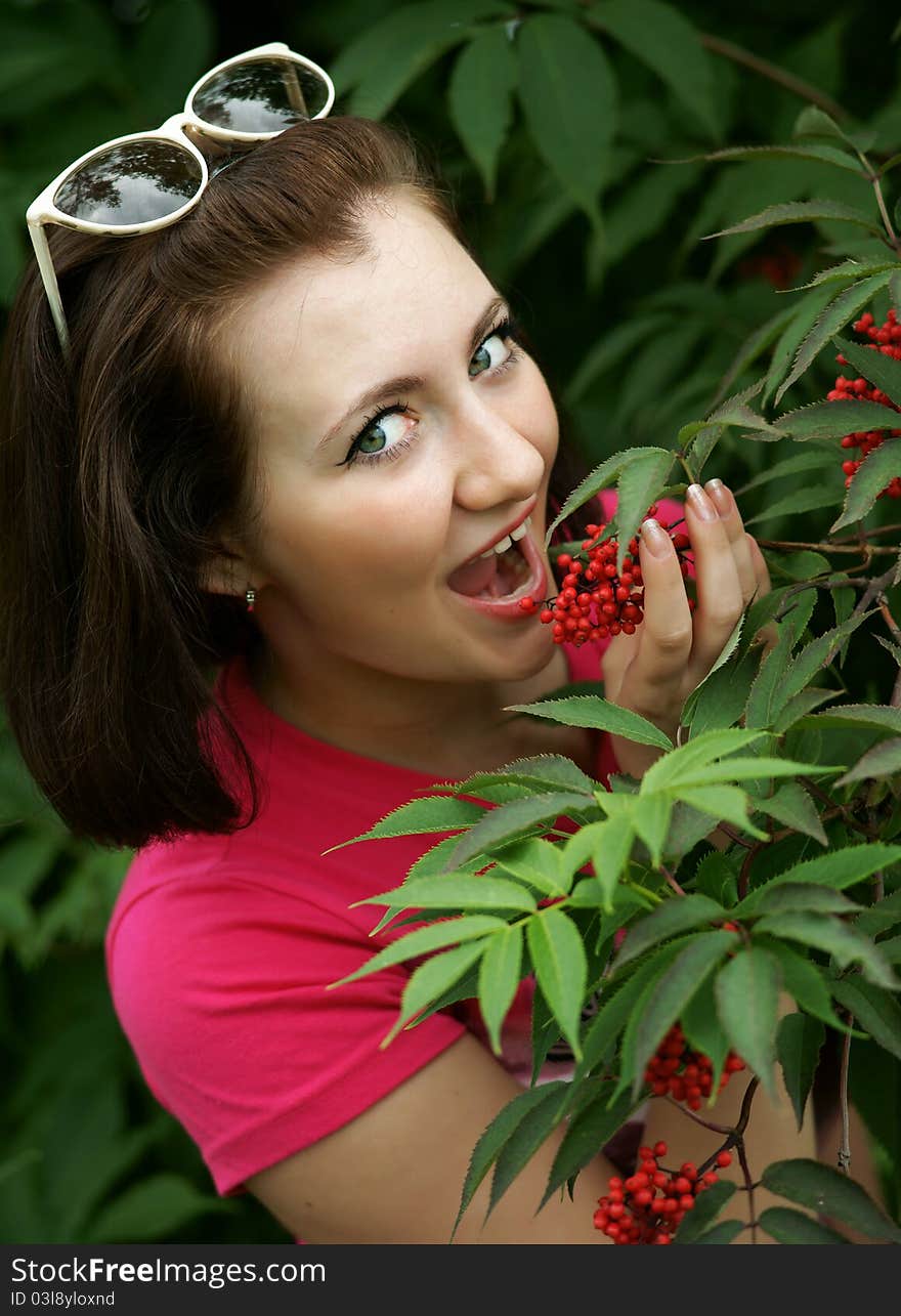 The cheerful girl with red berries