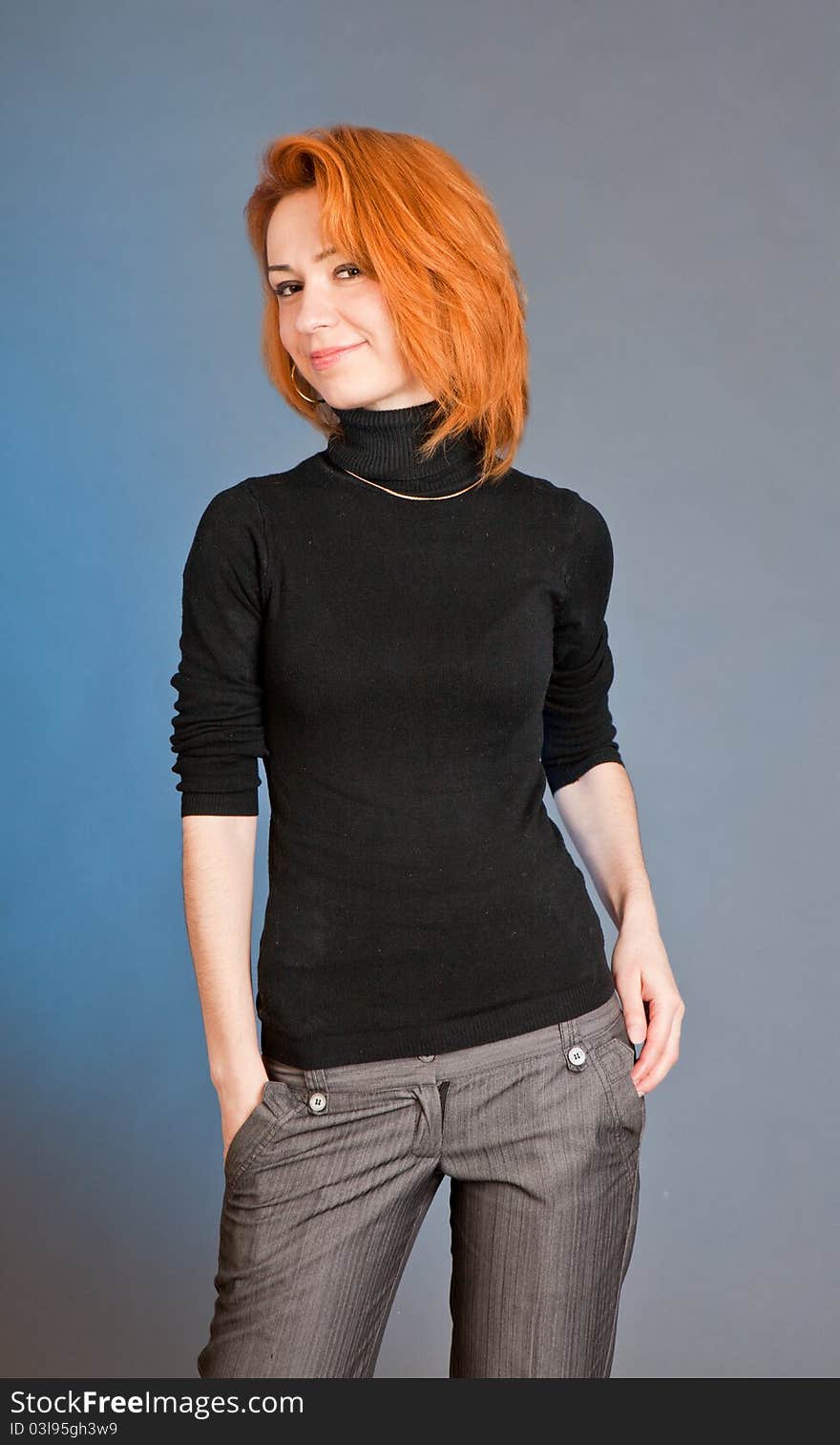 Portrait of the beautiful harmonous girl with red hair in studio