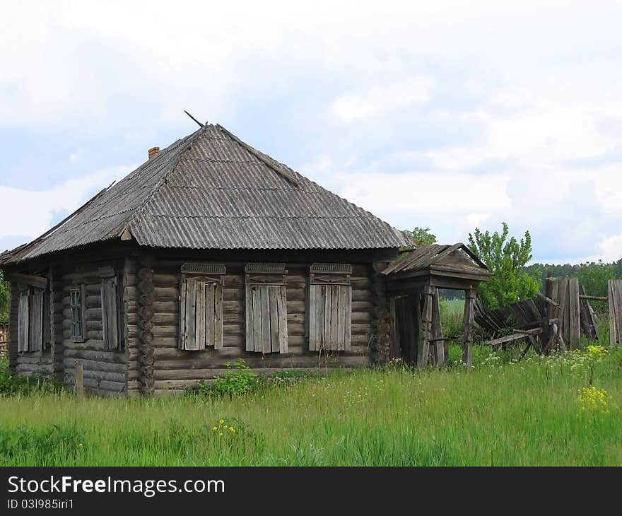 Abandoned wooden house with boarded up windows in the Russian countryside. Abandoned wooden house with boarded up windows in the Russian countryside.