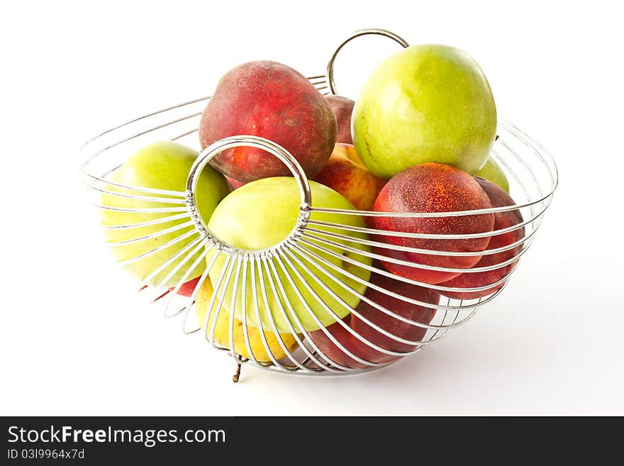 Apples and peaches in a vase on a white background