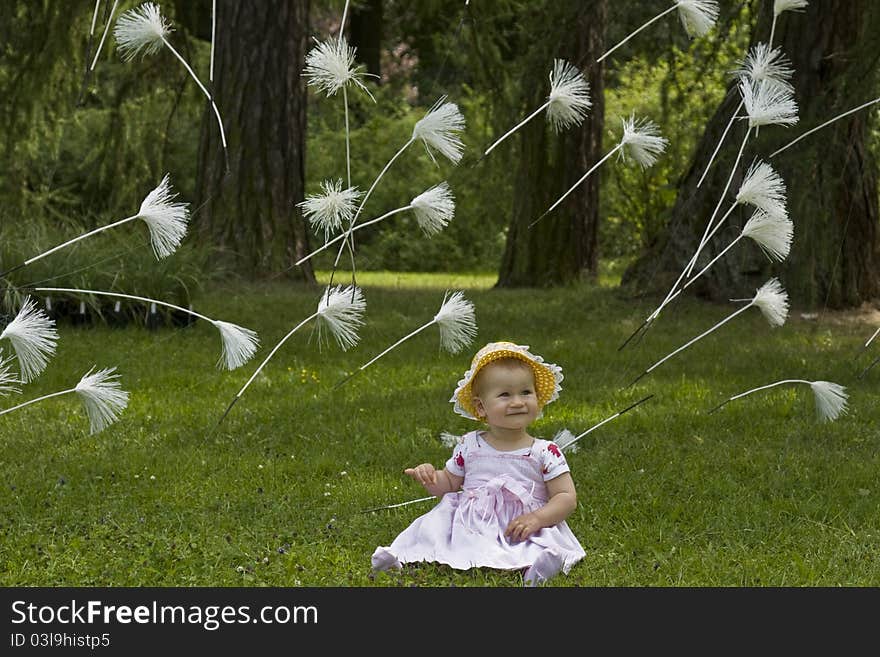 Baby with flying dandelion seeds