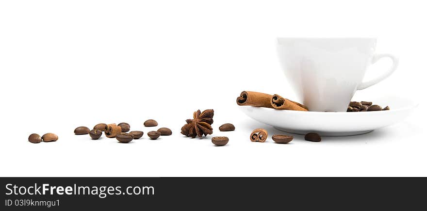 Cup of coffee and  cinnamon bark on a white background