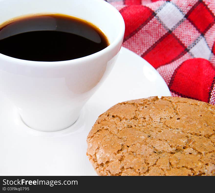 Cup of tea and cookie on a red tablecloth