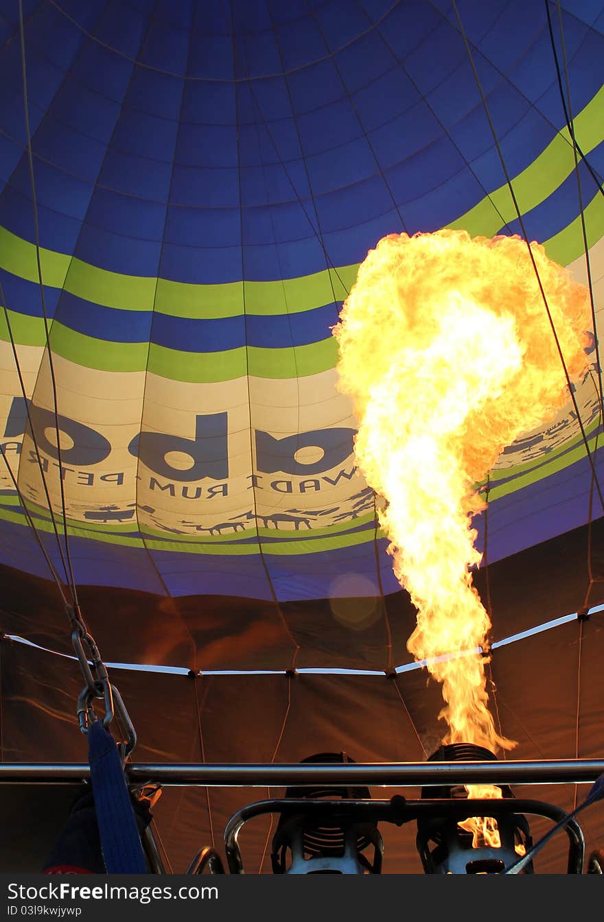 Hot air balloon with bright burning gas flame