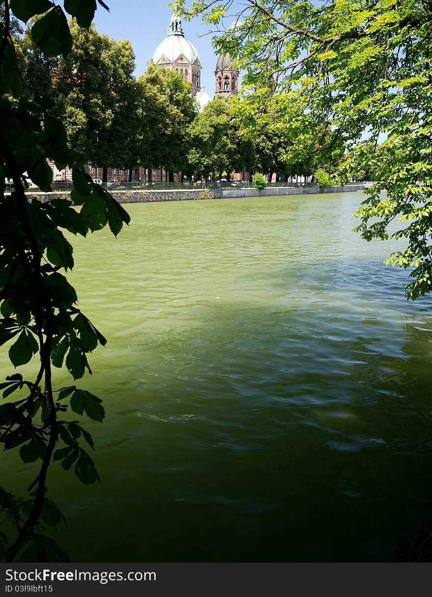 A shady place along the Isar River in Munich with the Church of St. Luke in the back. A shady place along the Isar River in Munich with the Church of St. Luke in the back.