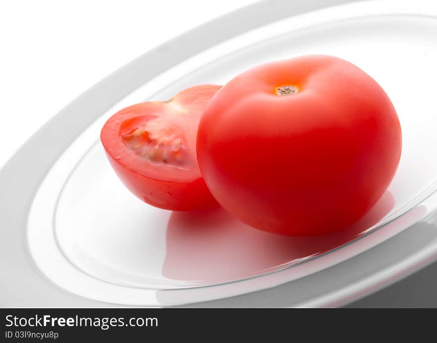 Ripe tomatoes on a white plate