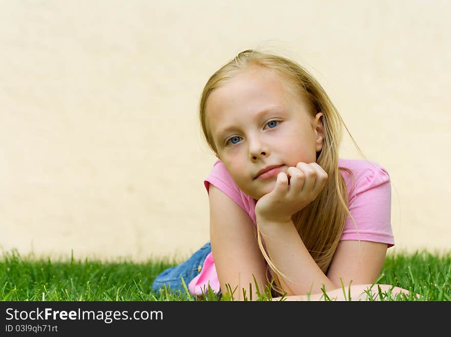 Blonde girl lying on the grass dreaming. Blonde girl lying on the grass dreaming