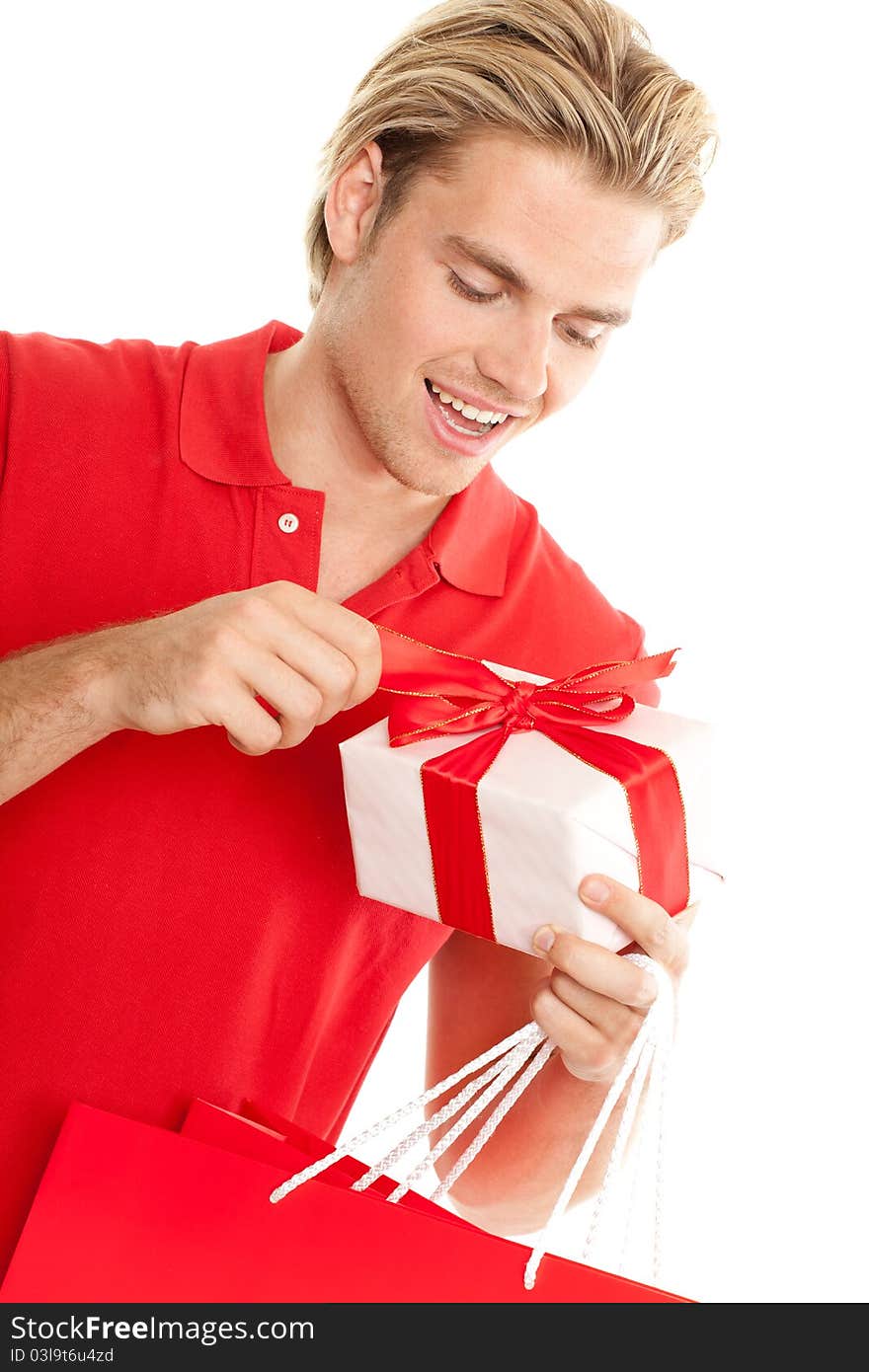 Young man opening a gift. Young man opening a gift