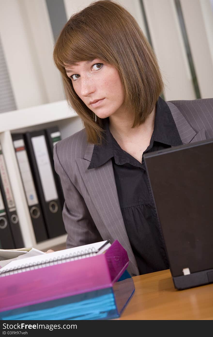 Young woman by office work with laptop