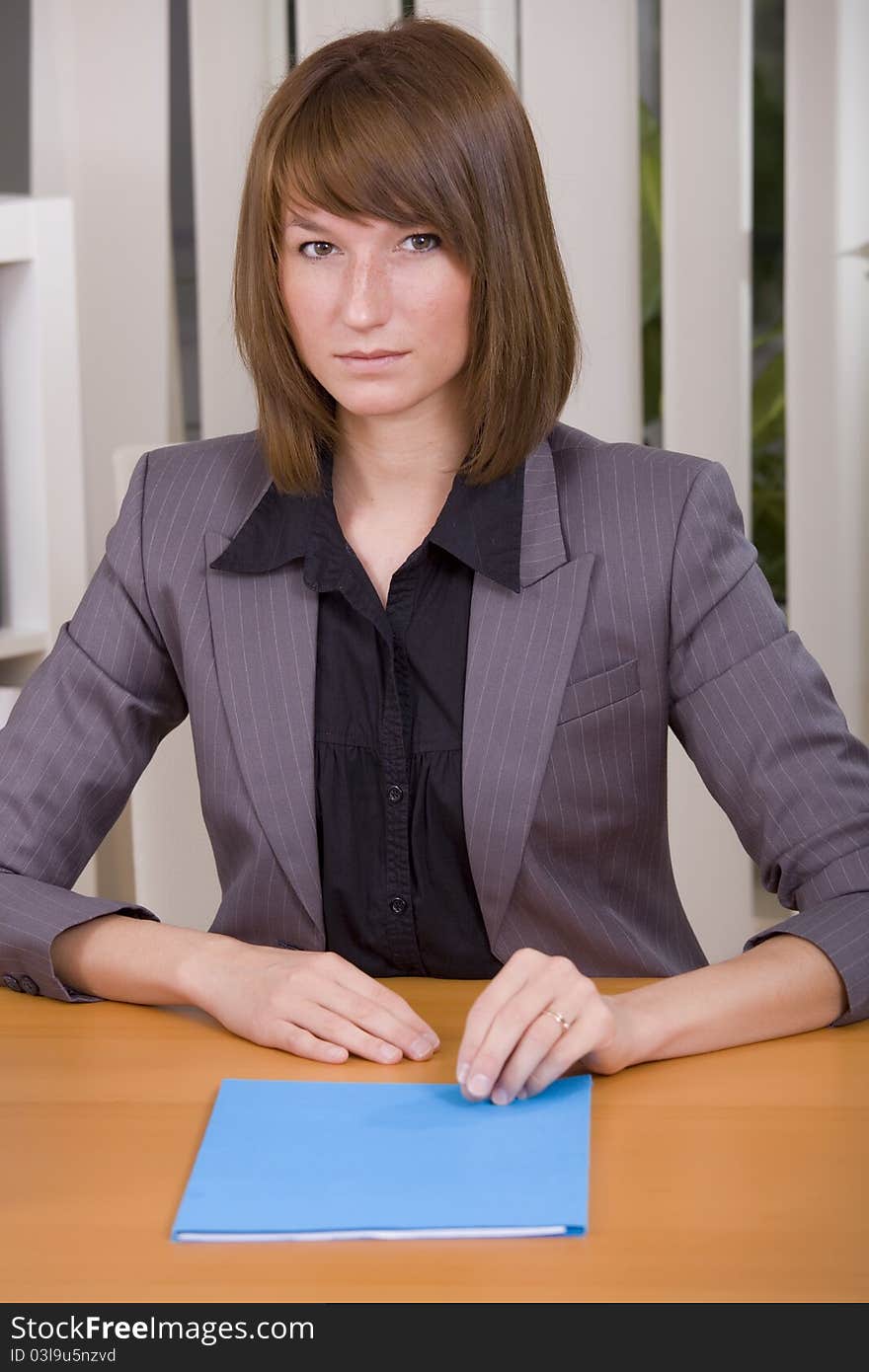 Woman with application file in office