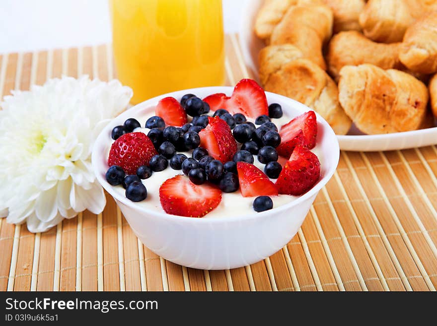 Early breakfast. Strawberries, cream and juice. The symbol of healthy lifestyles.