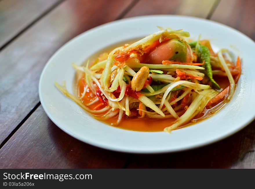 Thai papaya salad hot and spicy mixed from variety of vegetable closeup