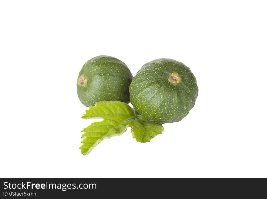 Two small figs and a leaf against a white background