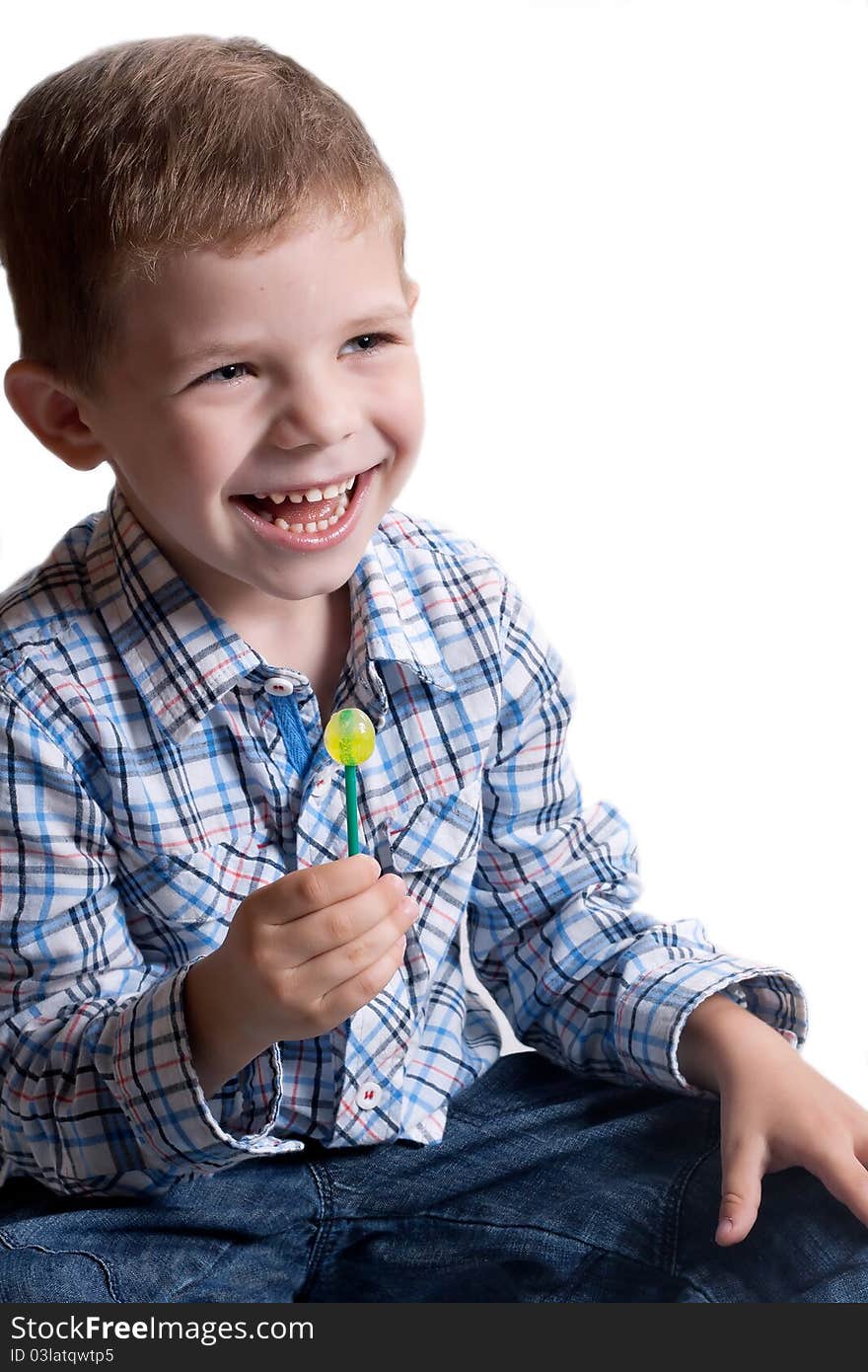 A little boy with candy on a white background