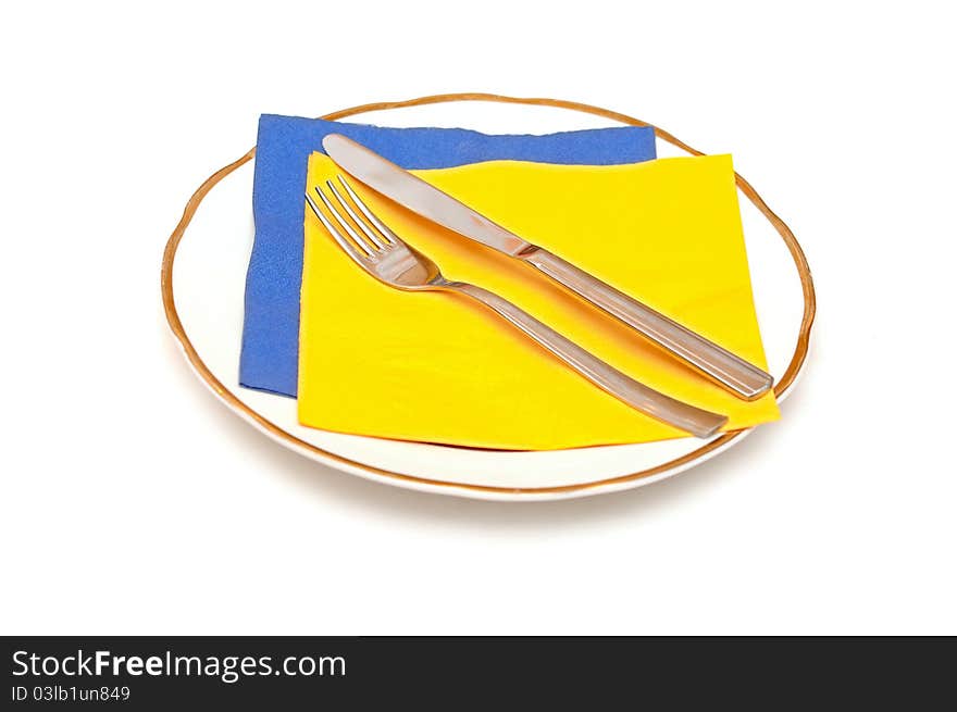 Knife fork napkin and plate isolated on white