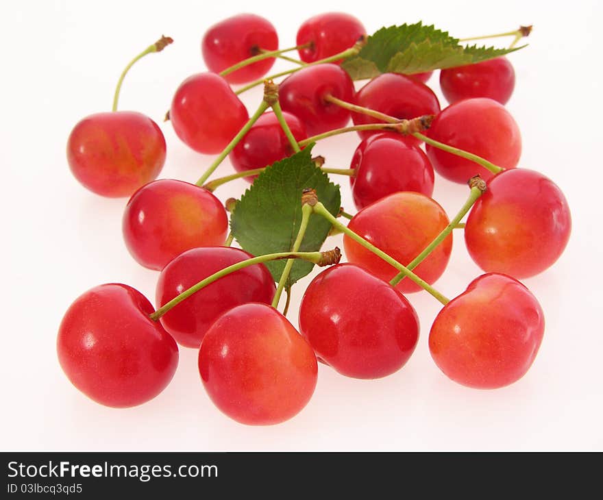 Group of red cherries with stalks and leaves