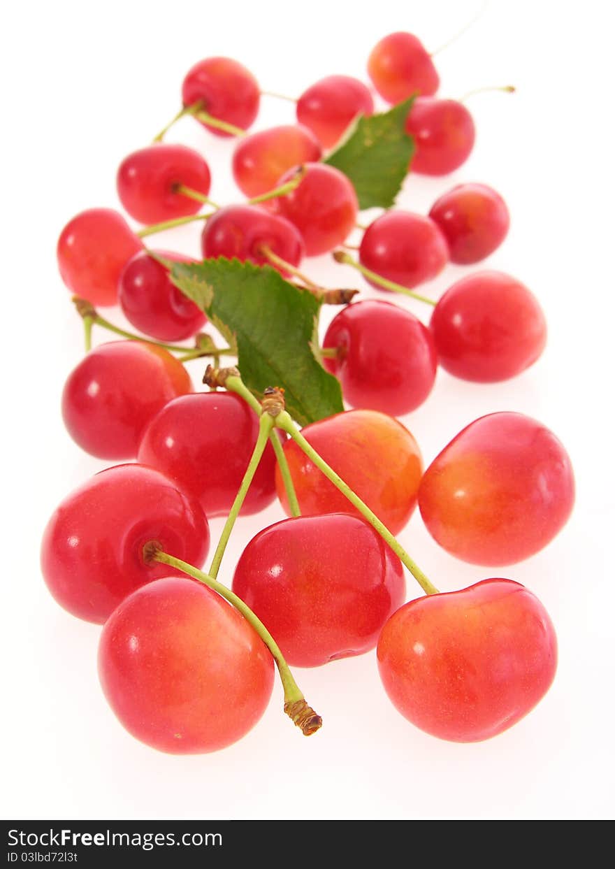 Group of red cherries with stalks and leaves